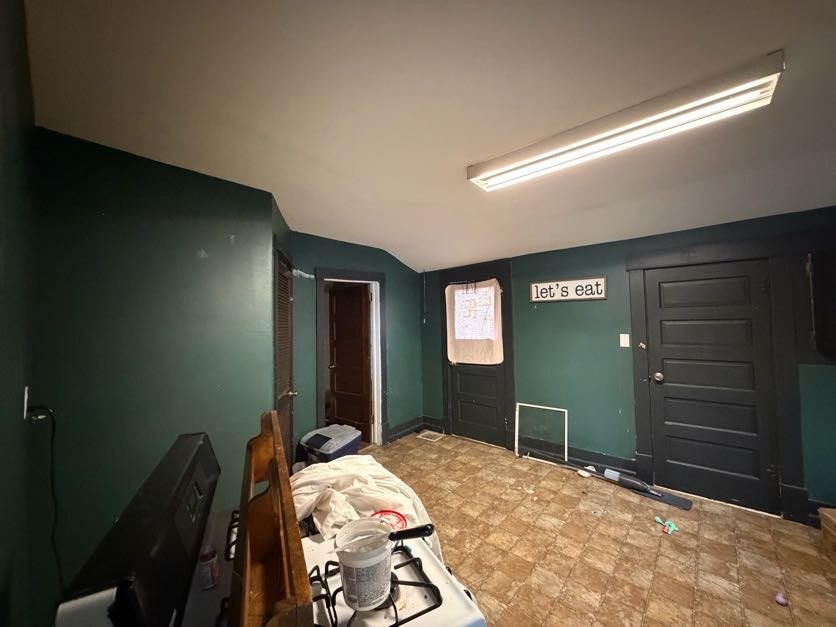 Dark-painted entry area with a light ceiling