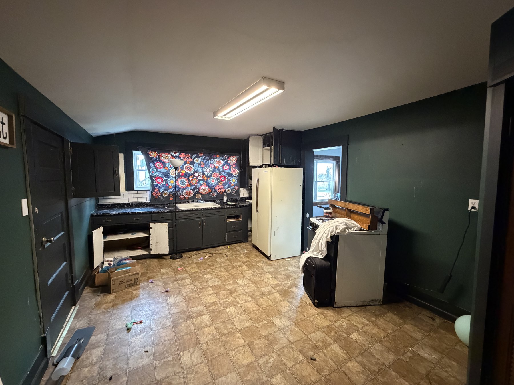 Dark-painted interior walls around an entry and kitchen area