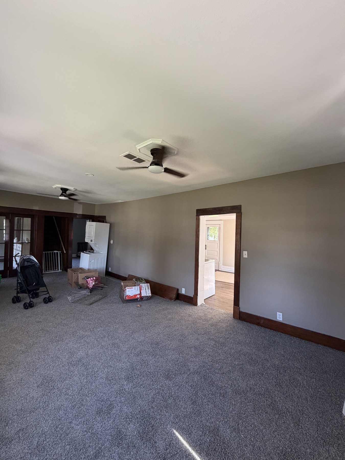 Living room walls and trim viewed toward an adjoining room